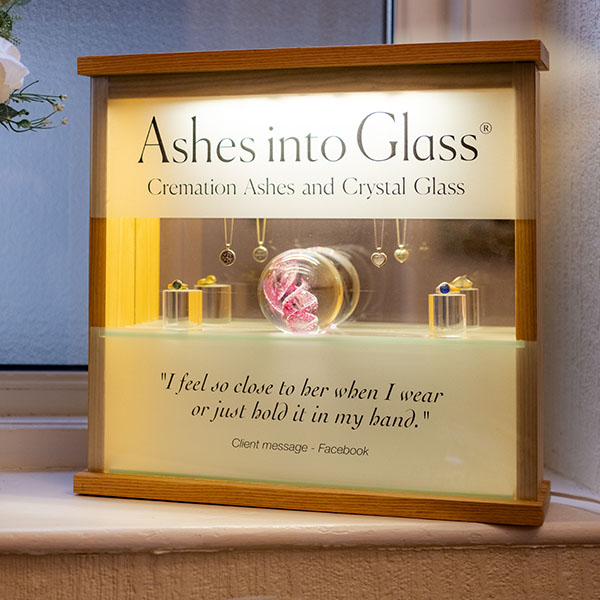 ashes into the glass with wooden frame